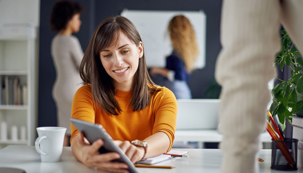 Woman in office setting using tablet device, eyewear sales