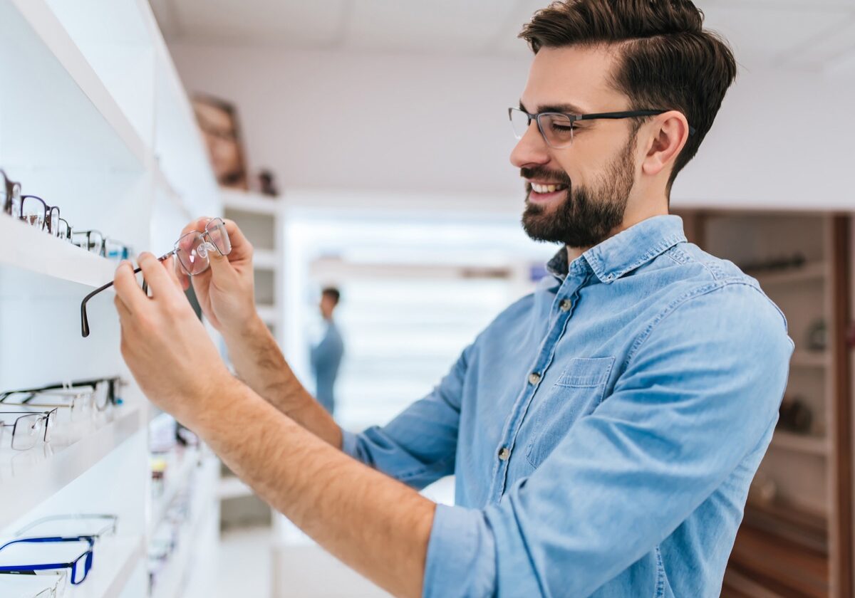 Man trying on glasses at the optometrist